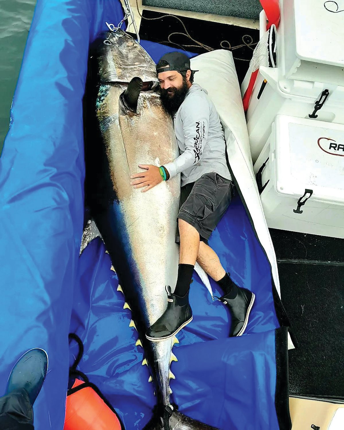 GIANT BLUEFIN: Jeff Sullivan caught this 600 pound, 100 inch giant bluefin tuna five miles off the Sakonnet River with fishing partners and friend Capt. Rob Taylor of Newport Sportfishing Charters. (Submitted photo)